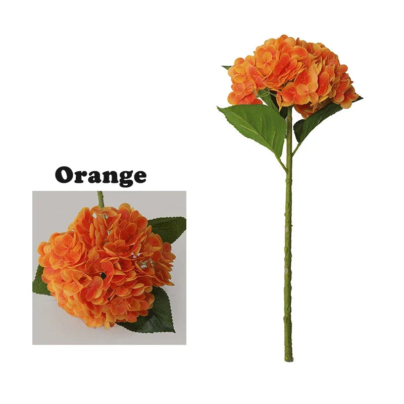 A branch of orange latex hydrangea artificial flowers with green leaves.