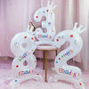 White foil balloons shaped like the number 3 and the letter W with crowns and birthday text