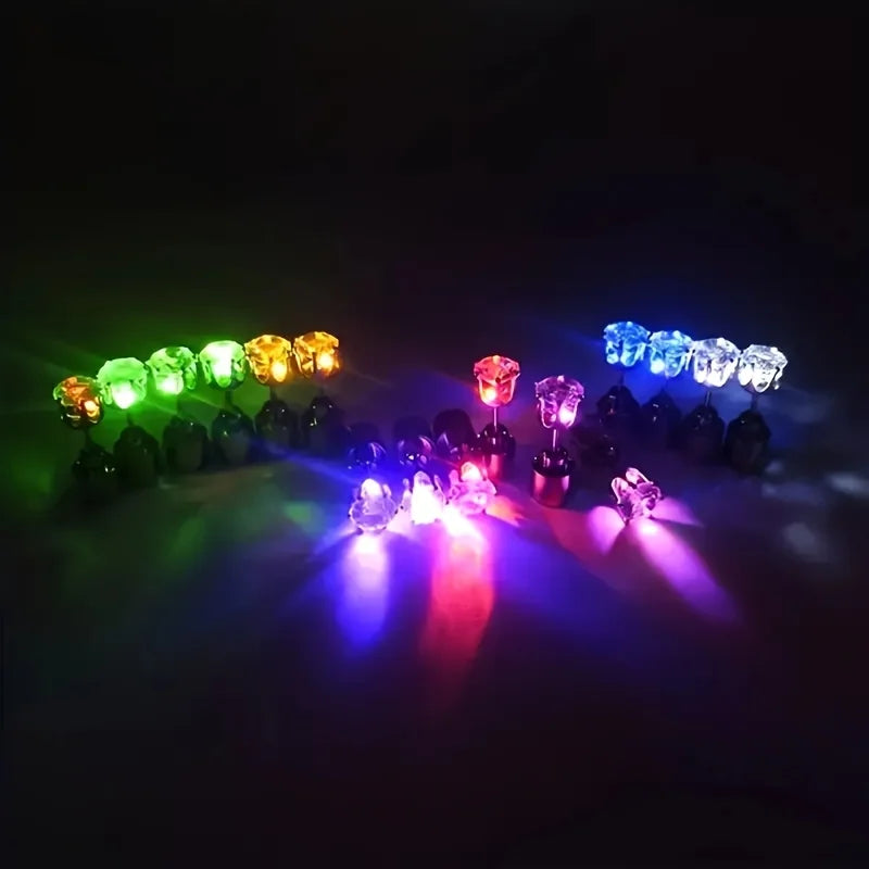 A display of LED light-up flashing stud earrings with color-changing zircon stones illuminating various colors.