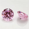 A close-up of a round cut pink gemstone and a triangular pink gemstone on a white surface.