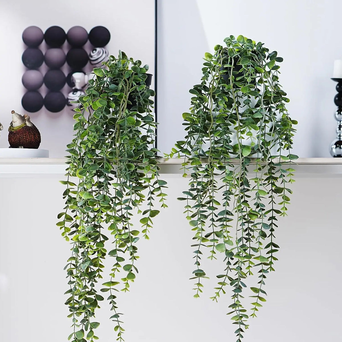 Artificial eucalyptus hanging plant with green leaves displayed on a shelf.