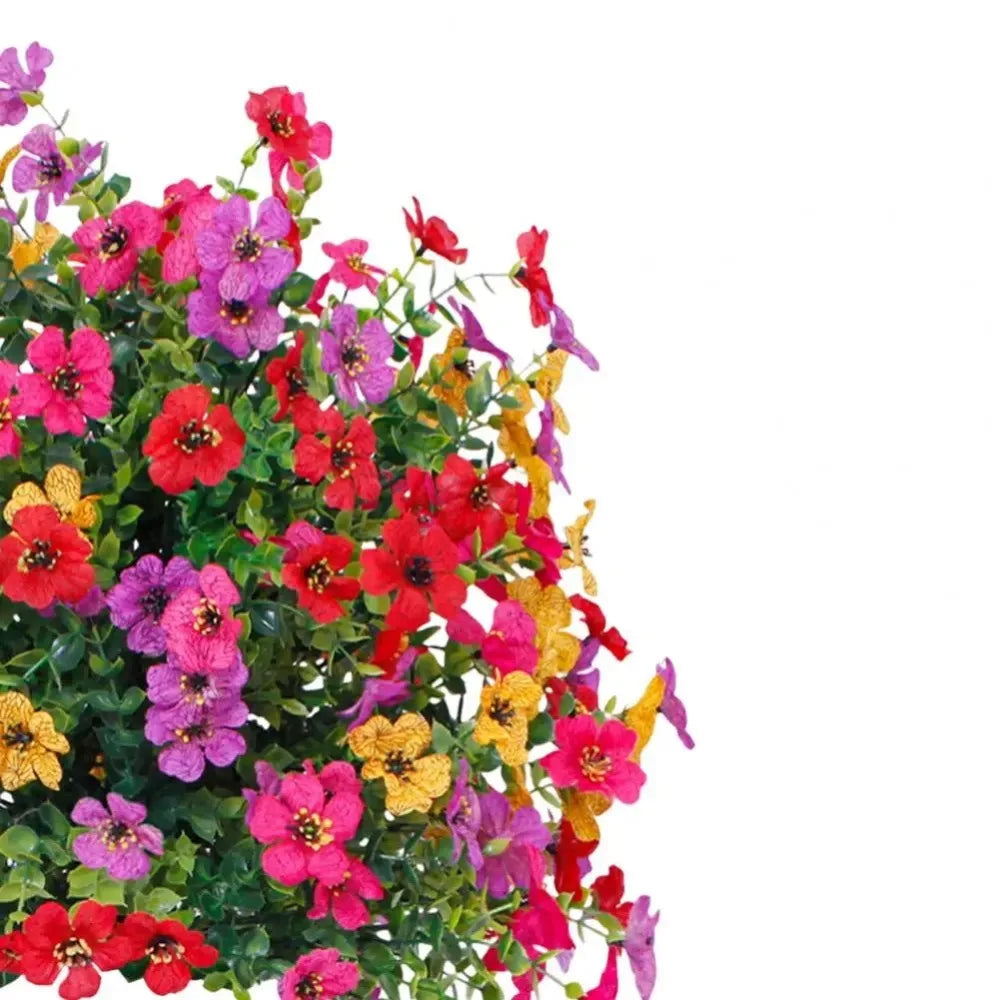 A vibrant mix of artificial flowers in shades of pink, red, purple, and yellow.