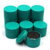 A set of teal metal candle tins with matching lids arranged on a white background.