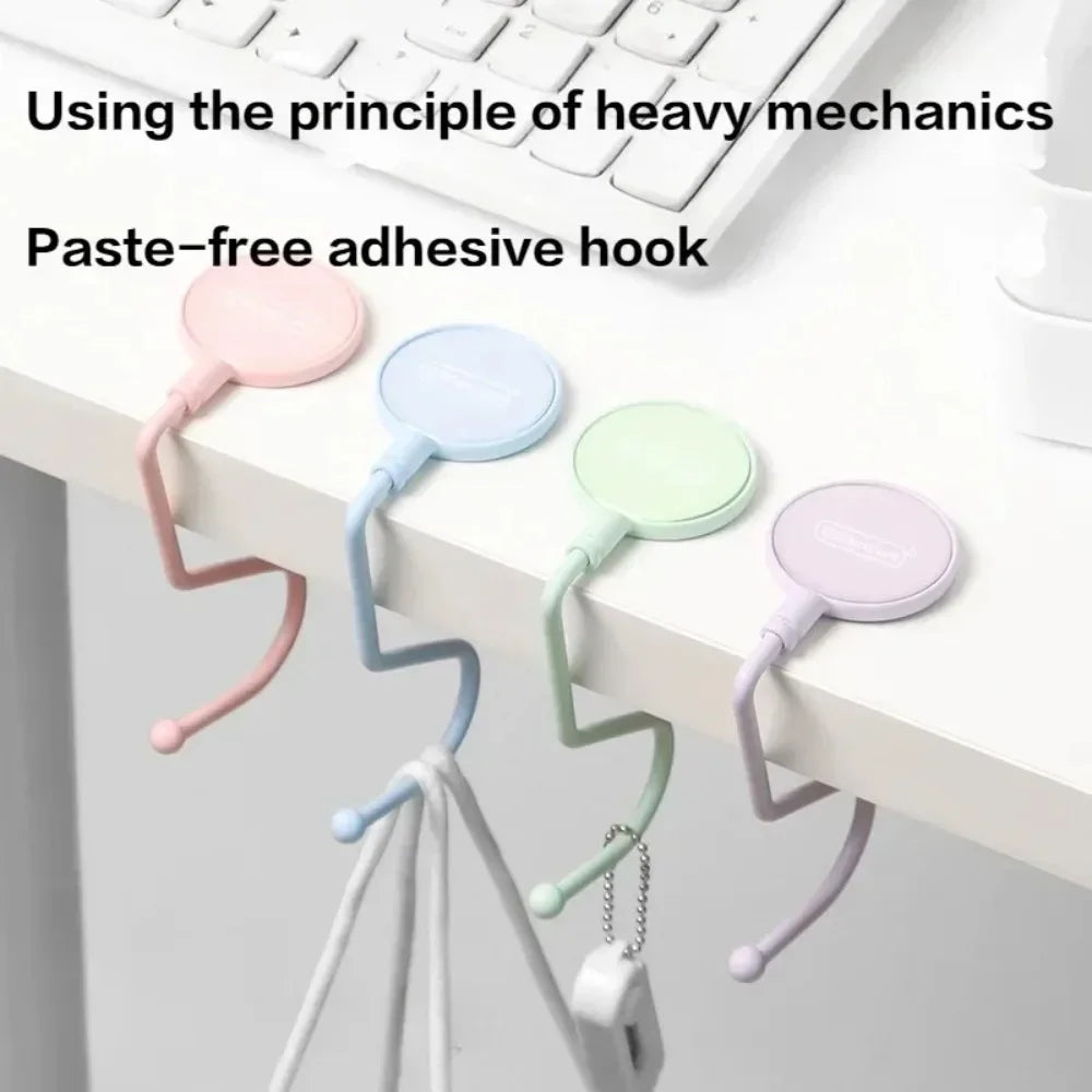 A set of paste-free adhesive hooks in various pastel colors attached to a white surface.