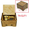 A wooden music box featuring an ornate lid and a brass melody mechanism.