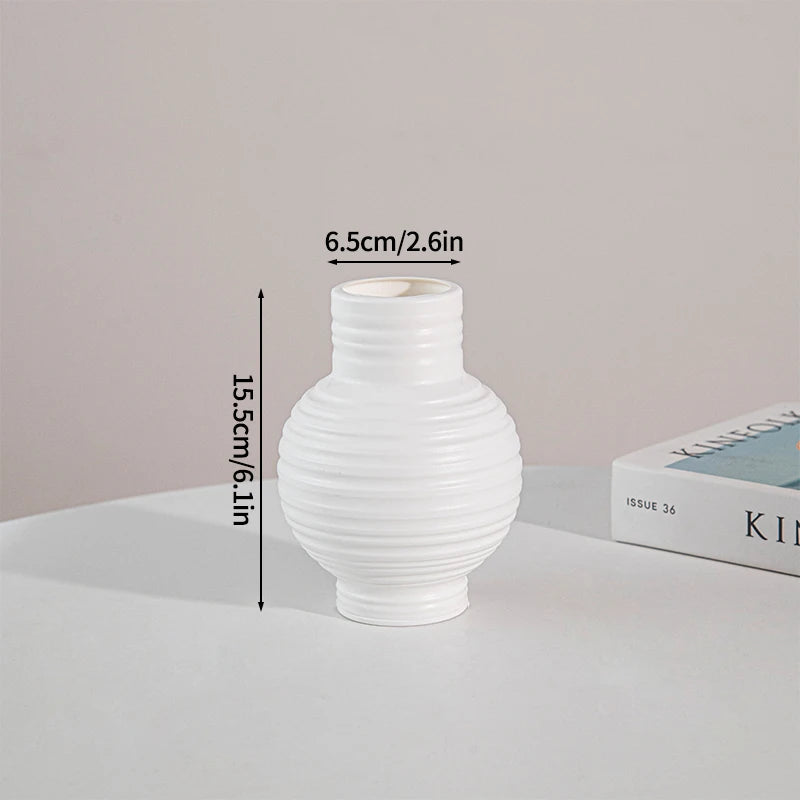 White ceramic style plastic vase with a ribbed design shown against a light background.