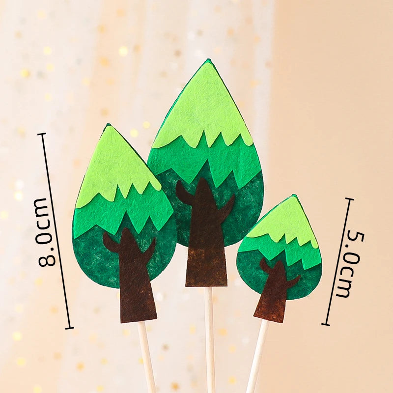 Three green tree-shaped cake toppers on wooden sticks with measurement lines.