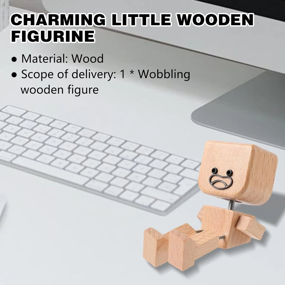 A small wooden figurine with a face is shown next to a laptop keyboard.