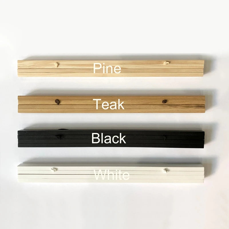 A display of four magnetic wooden art frames in Pine, Teak, Black, and White.