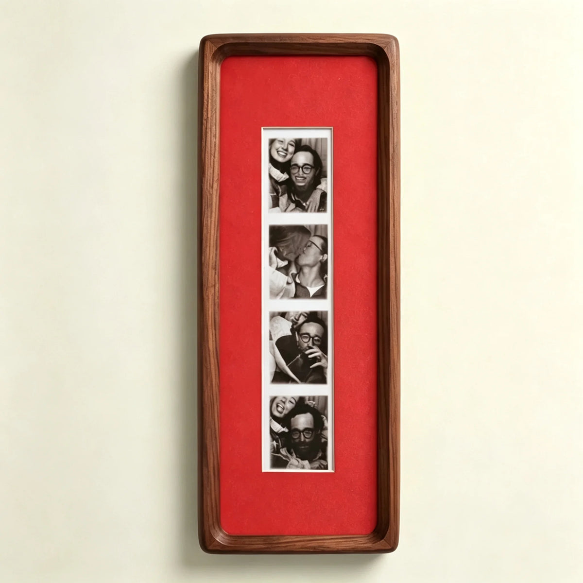 A vertical wooden frame with a red background displaying a series of small photos.