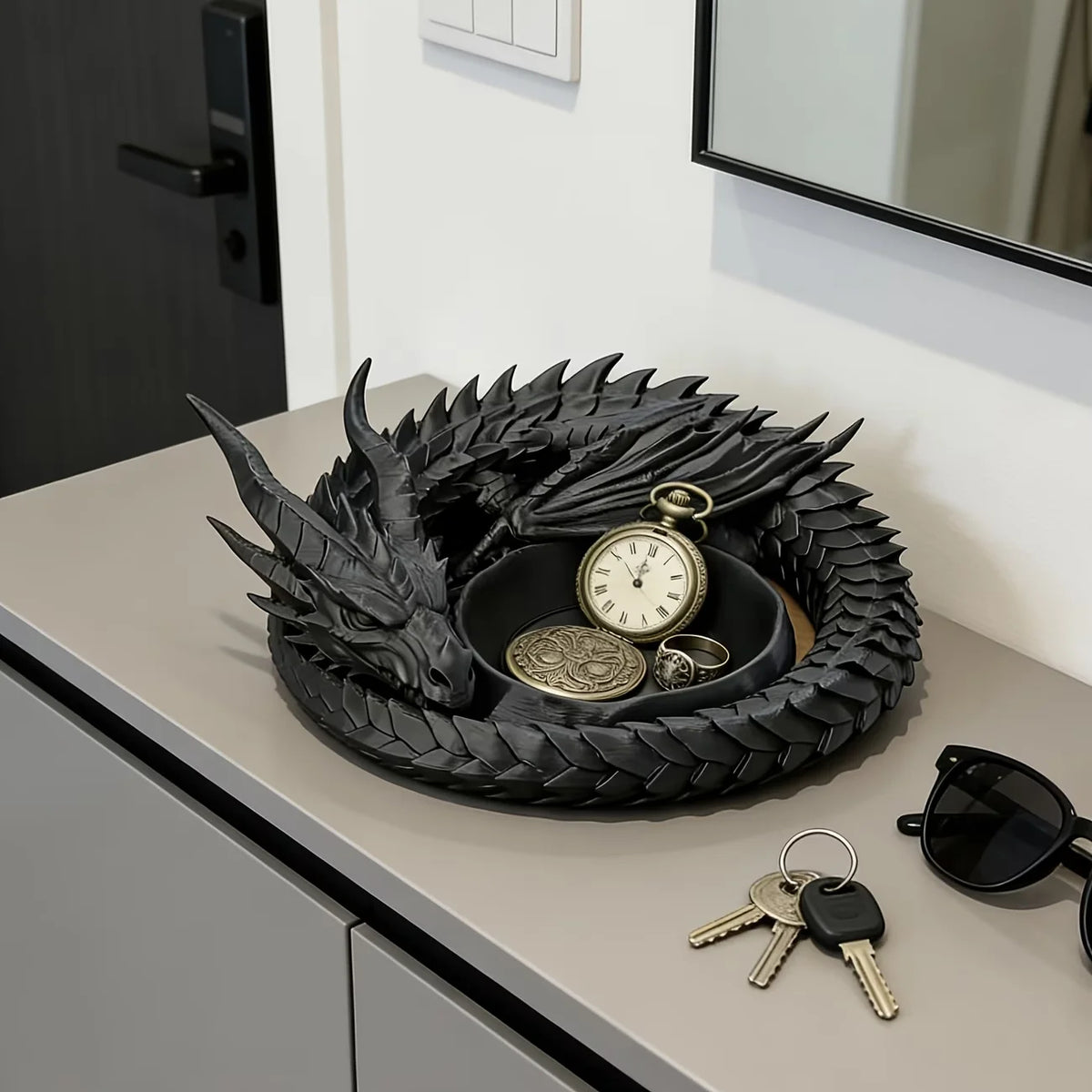 A black dragon-themed desktop storage tray organizer with a circular, textured design and gold accents.