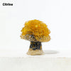 A natural crystal mushroom tree sculpture featuring a bright yellow top and a dark base.