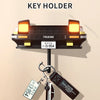 Wall mounted key holder featuring a classic car headlight design with illuminated LED lights.