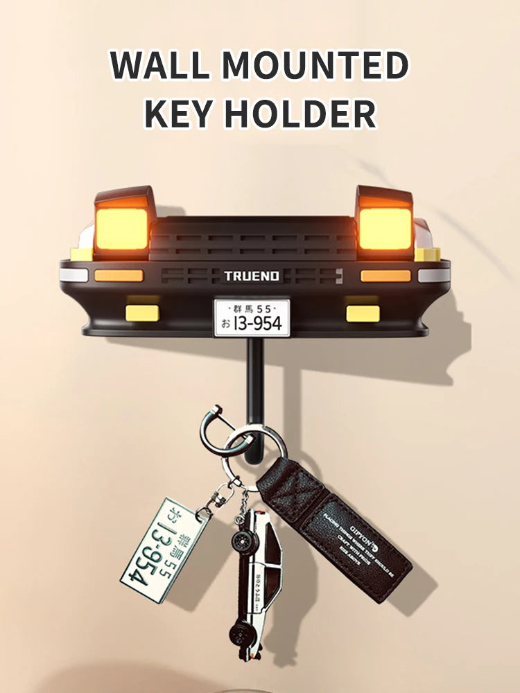Wall mounted key holder featuring a classic car headlight design with illuminated LED lights.