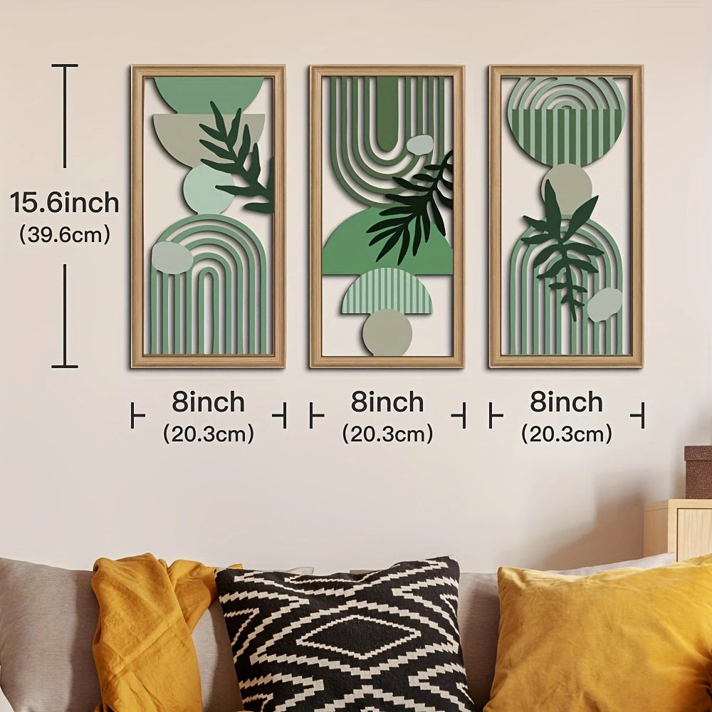 A set of three framed wall art pieces featuring green and beige botanical patterns on light wood frames.