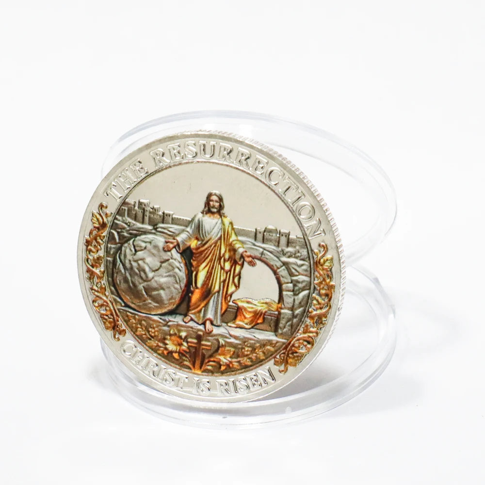 A clear plastic coin featuring a depiction of Jesus during the Resurrection, surrounded by ornate detailing.