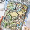 A clear sticker book filled with detailed kawaii miniature 3D scenes and buildings for kids.