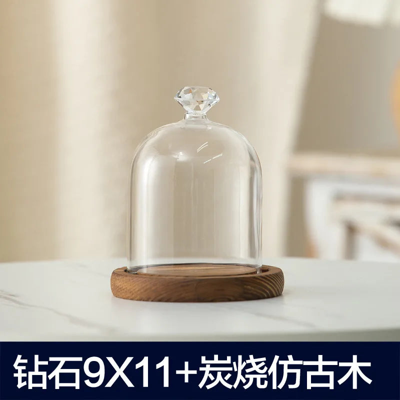 Clear glass aromatherapy candle holder with a dome cover and a wooden base