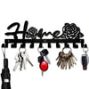 Decorative metal wall-mounted key holder featuring seven hooks for keys and accessories