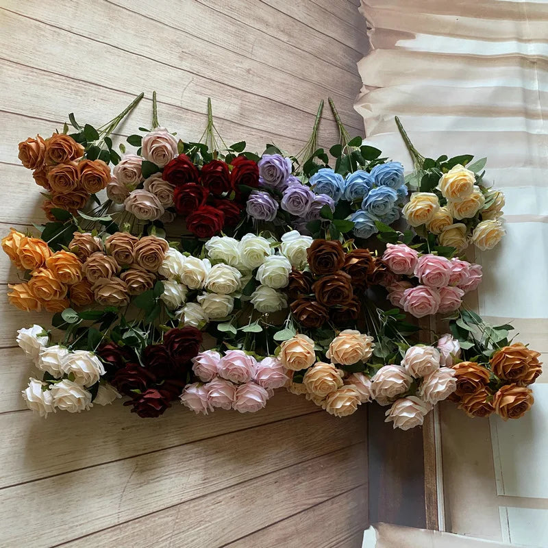 A colorful silk rose bouquet featuring various shades of orange, pink, red, purple, and blue roses.