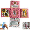 Handcrafted pocket devotional with a cross-shaped pouch featuring religious imagery on pink fabric.