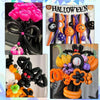 A collection of matte black latex balloons, some with orange accents, arranged for Halloween party decorations.