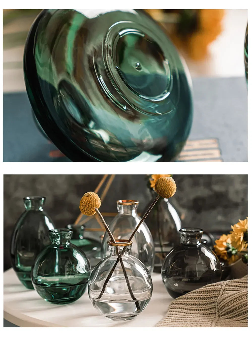 A set of three clear glass mini vases with stems and leaves arranged on a white surface.