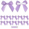 A collection of purple satin ribbon bows with white adhesive backing for crafting and gift wrapping.