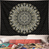 Black tapestry wall hanging featuring a detailed golden and white bohemian mandala design.