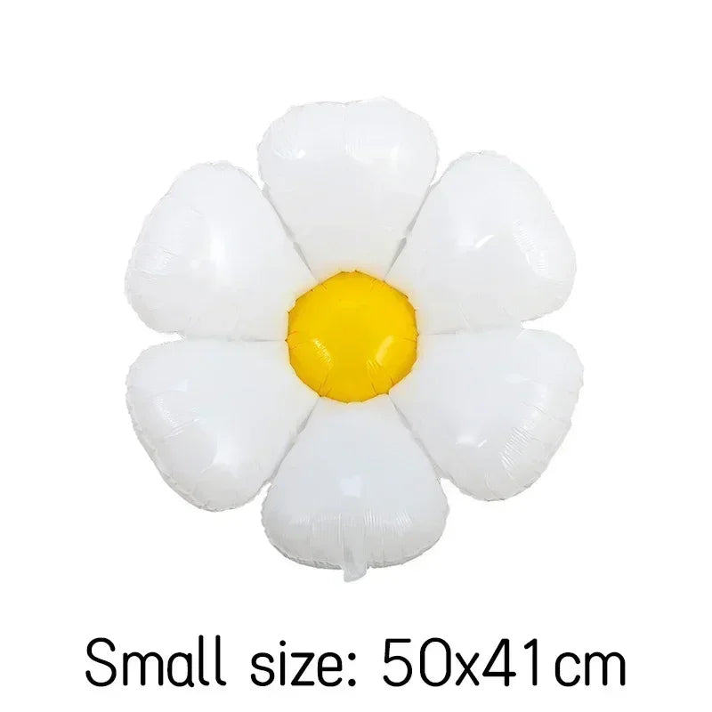 A cluster of white and yellow foil balloons arranged in a flower shape.