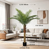 Artificial golden palm tree with green fronds displayed in a modern living room setting.