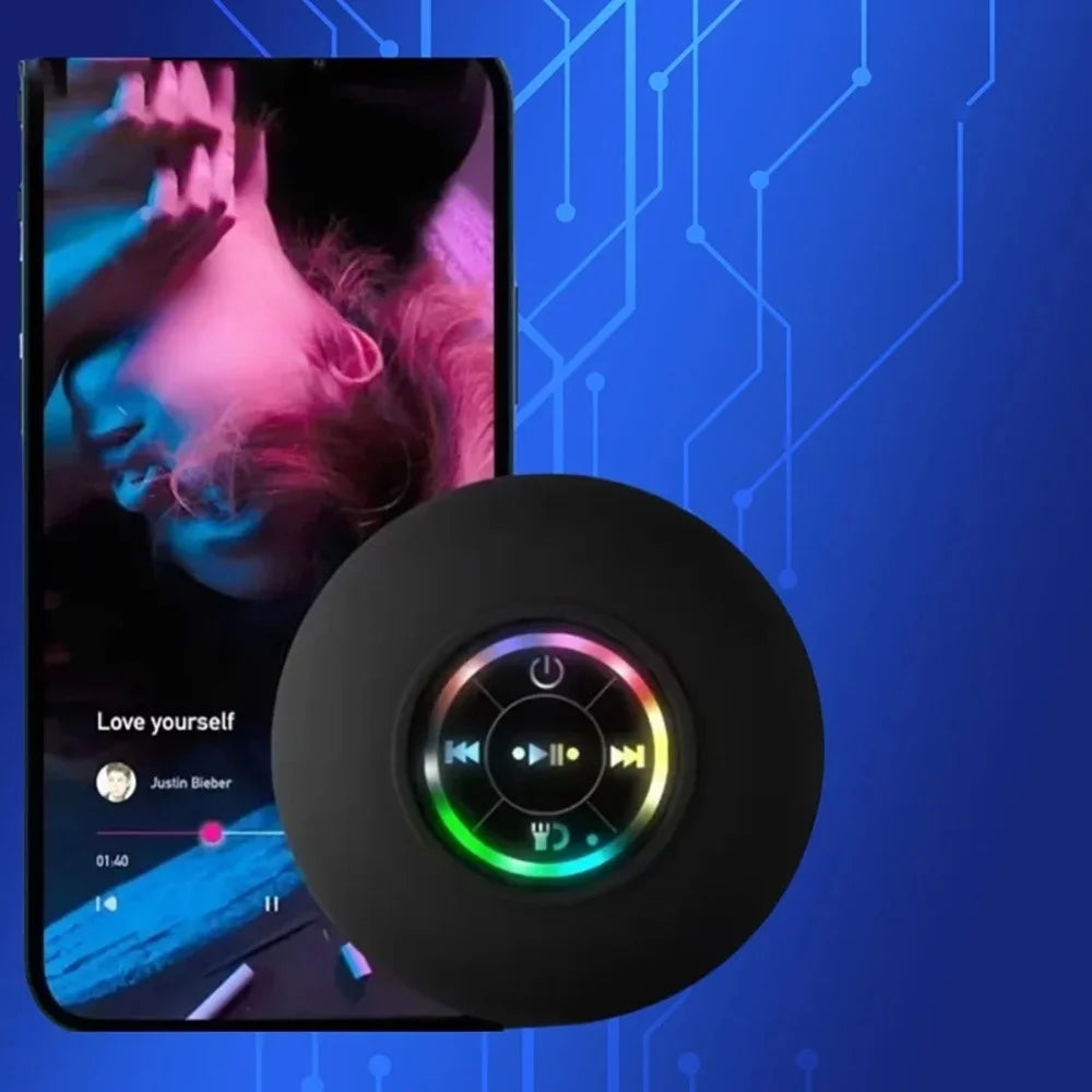 A black waterproof Bluetooth speaker with a suction cup is shown next to a smartphone displaying music controls.