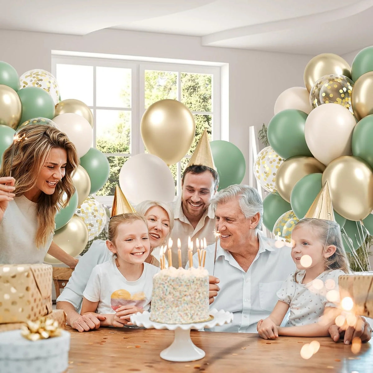 A family celebrates with a cake and balloons in a bright room, featuring sage green and gold colors.
