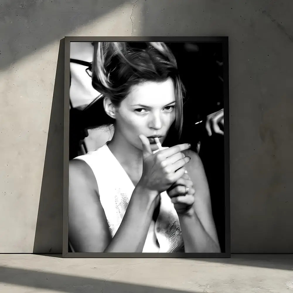 Black and white portrait of a woman with her hair styled up, holding a cigarette, against a dark background.