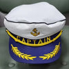 A white captain's hat with gold trim and a purple hat featuring a gold laurel wreath.