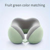 A light green U-shaped memory foam neck pillow shown in a close-up view.