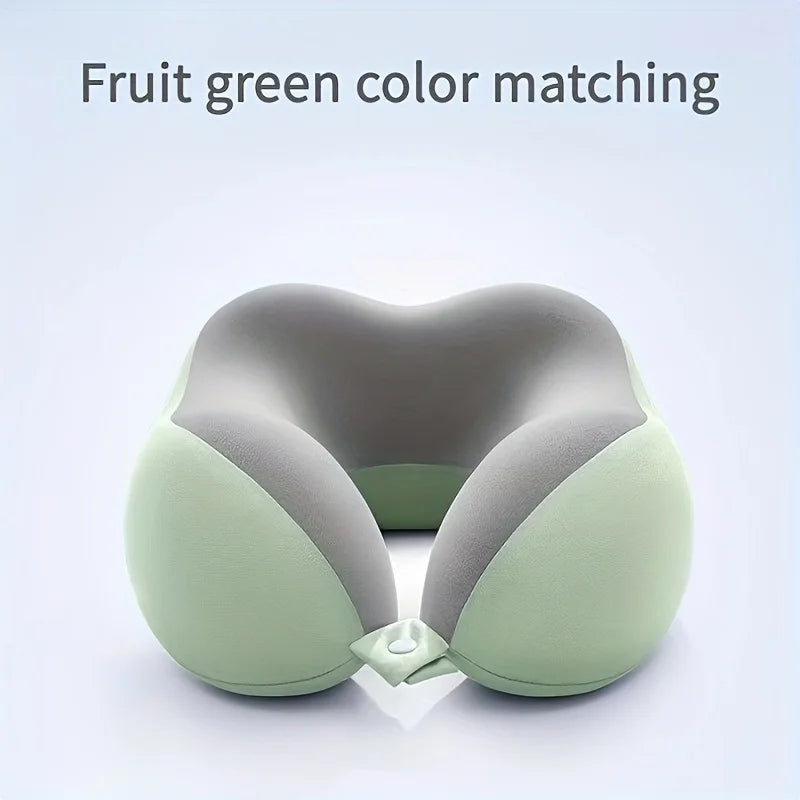 A light green U-shaped memory foam neck pillow shown in a close-up view.