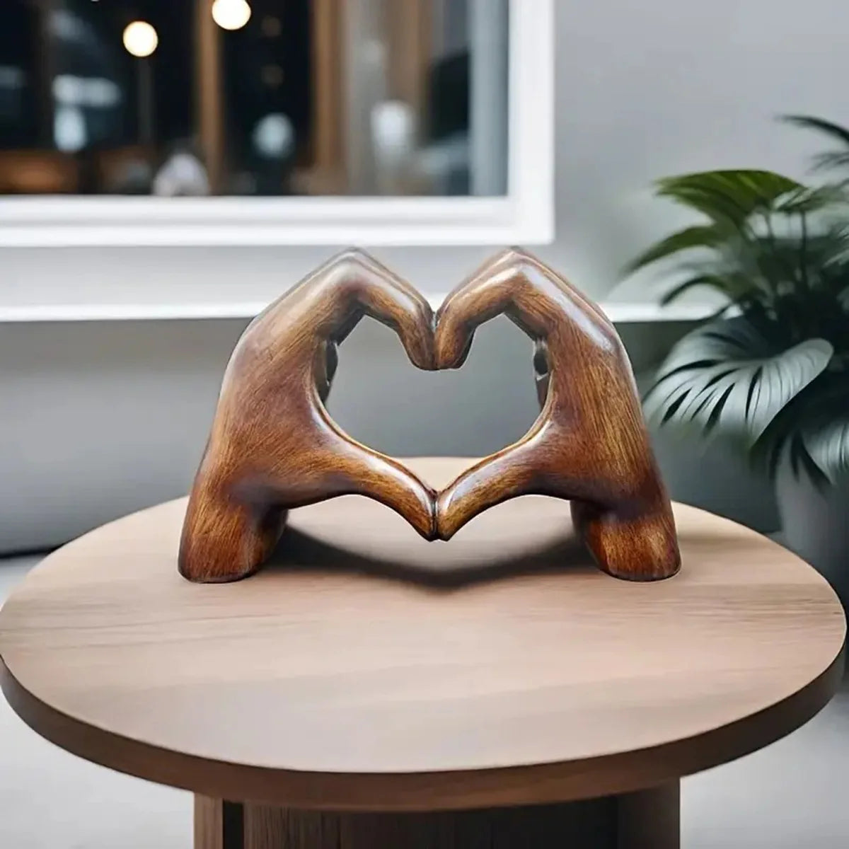 A heart-shaped wooden sculpture carved from resin resting on a light wood table.