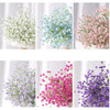 Bouquets of artificial gypsophila flowers in white, blue, pink, and purple for wedding and home decor