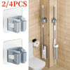 Two wall mounted mop and broom holders in silver and white for toilet or bathroom use