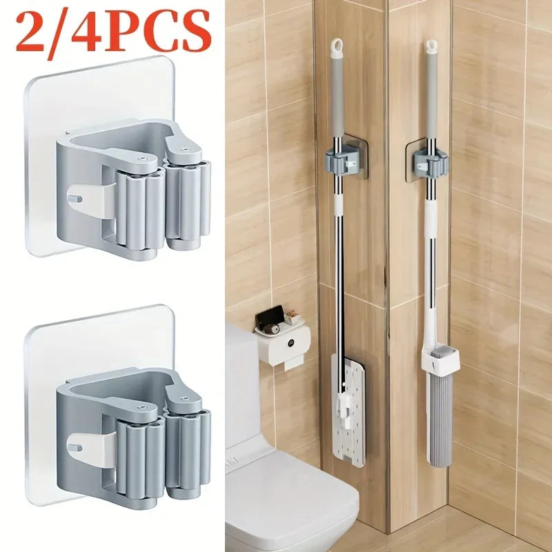 Two wall mounted mop and broom holders in silver and white for toilet or bathroom use
