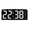 A black digital alarm clock displaying the time 22:38 with day of the week indicators.