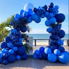 A large balloon arch garland in royal blue and navy blue colors set up outdoors.