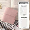 A pink faux leather photo album with a cover and internal pages shown next to a magazine.