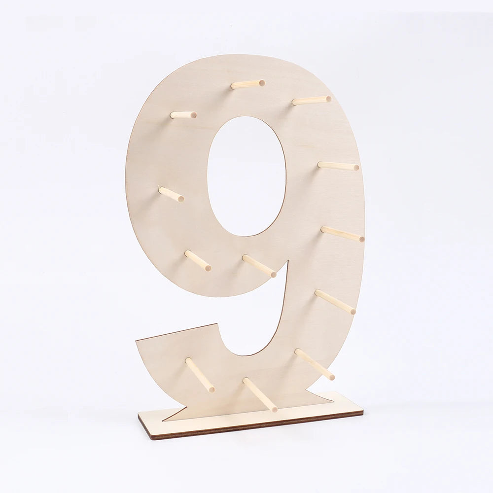 A light wood display stand shaped like the number 9, featuring small wooden sticks for decoration.