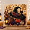 Diamond painting wall decor featuring a black witch silhouette, crescent moon, and autumn foliage with gold glitter accents.