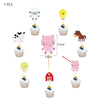 A set of seven farm animal cake toppers, including a cow, duck, pig, and horse, for a birthday party decoration kit.