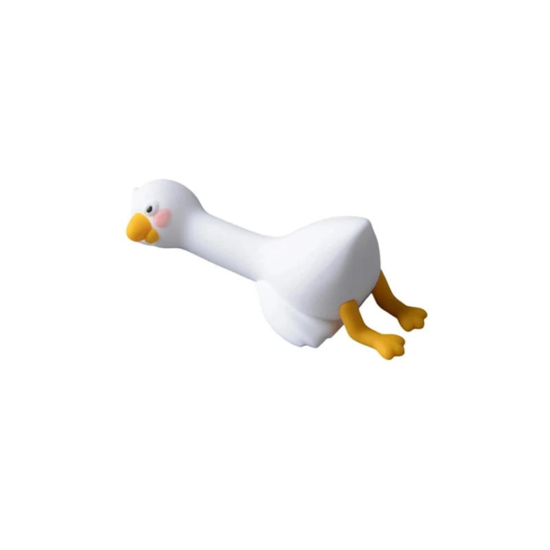 A white resin cartoon duck figurine with yellow feet and beak.