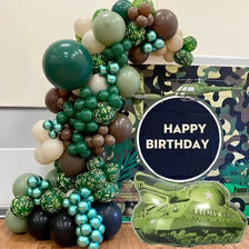 A green and brown foil balloon wreath set shaped like a military tank car on a camouflage background.