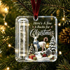 Clear acrylic ornament featuring a white reindeer, Christmas tree, and gift box design with a red velvet ribbon.